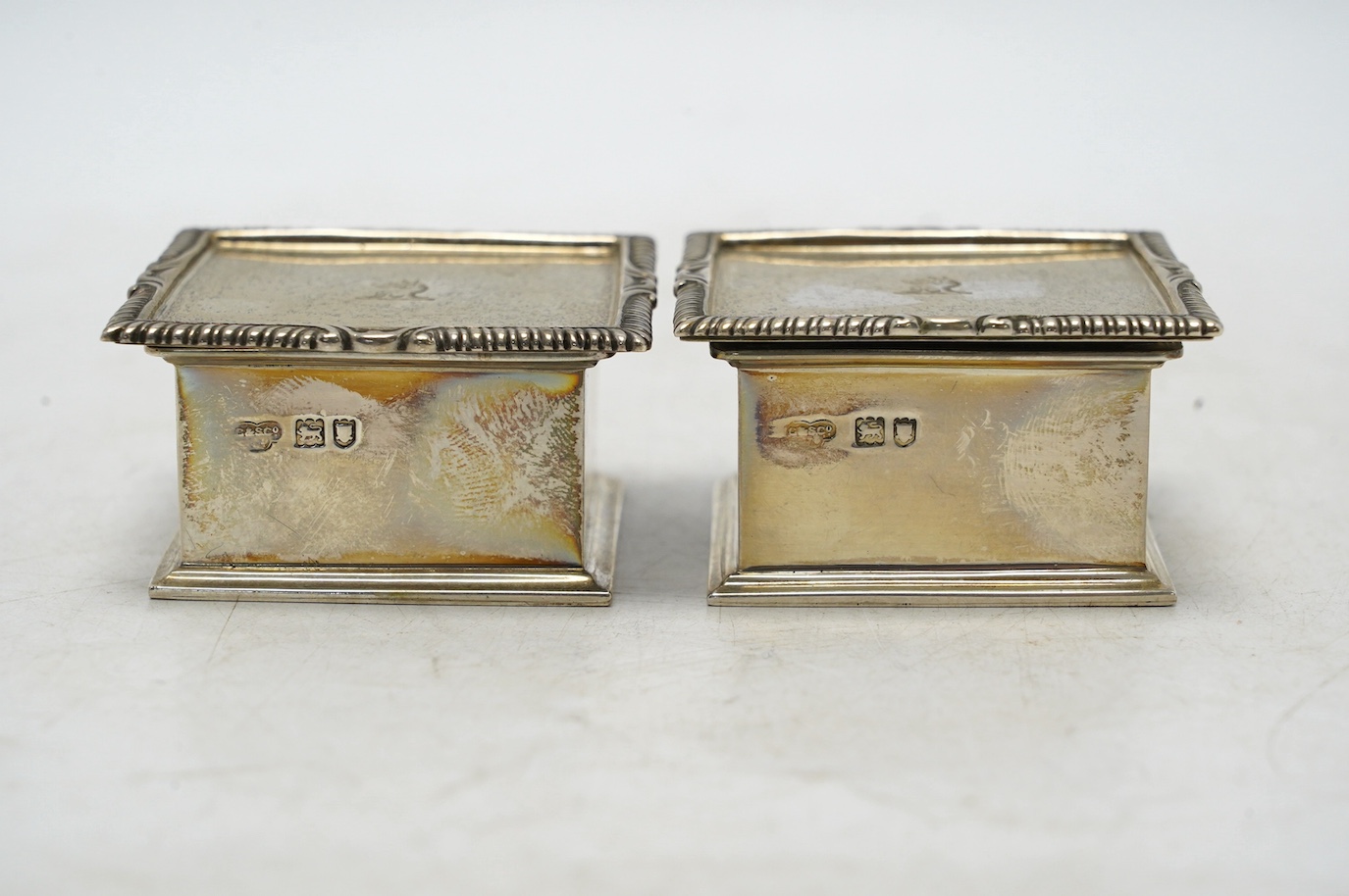 A pair of George V silver square boxes with hinged covers, by Goldsmiths & Silversmiths Co Ltd, London, 1914, 59mm, 7.2oz. Condition - good
